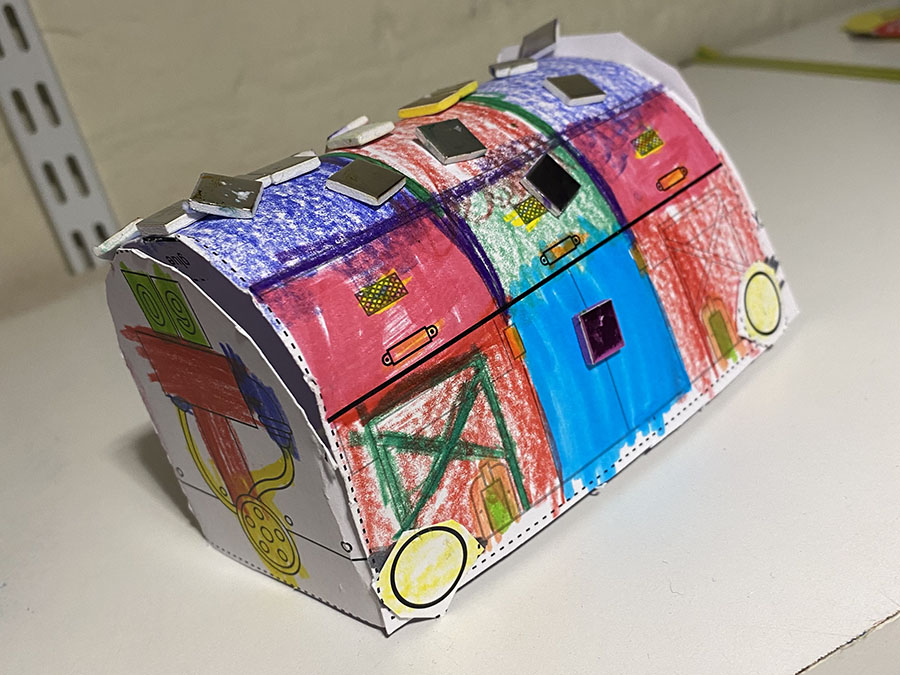 A colourful paper model of a Mail Rail train.